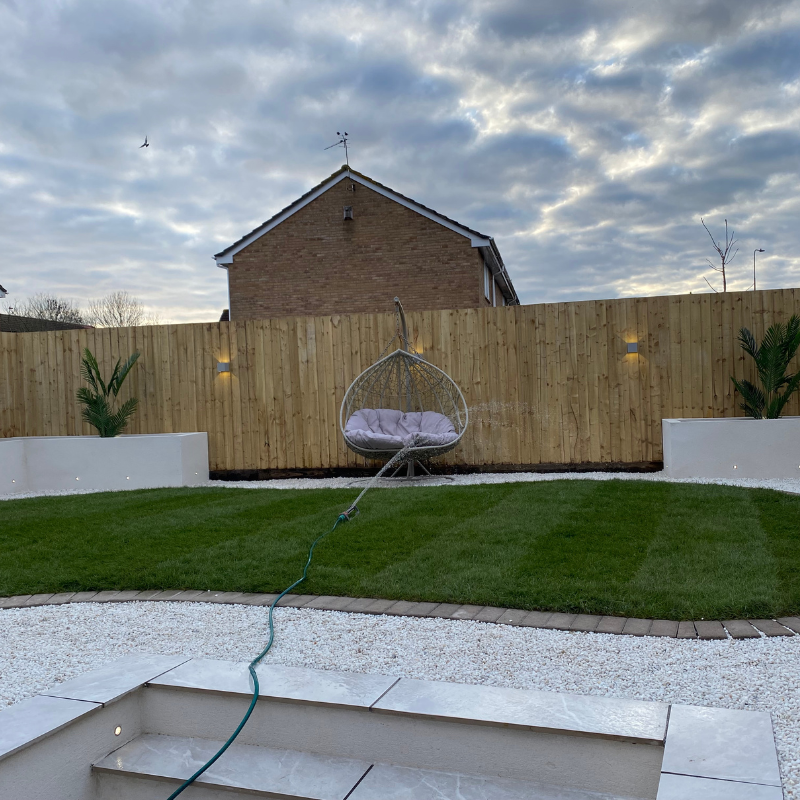 Completed garden renovation featuring lawn, retaining wall and patio area.